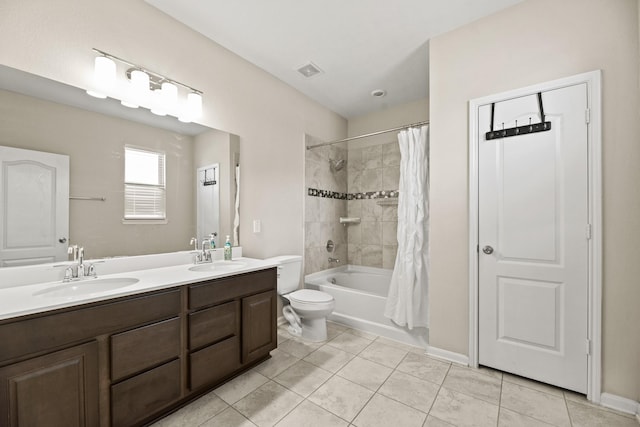 full bathroom with tile patterned floors, vanity, toilet, and shower / bath combination with curtain