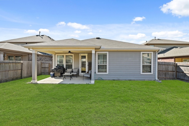 rear view of house with a patio area, a yard, and ceiling fan