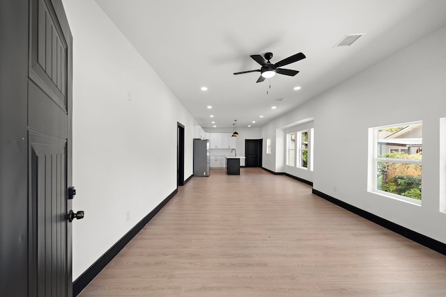 hallway with light hardwood / wood-style flooring