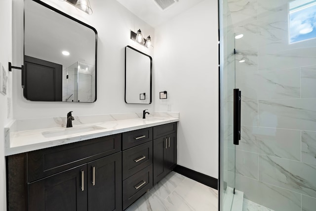 bathroom with vanity and a shower with door