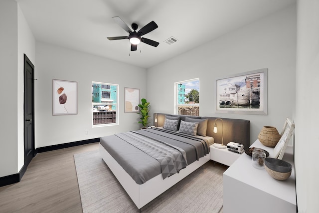 bedroom with ceiling fan and wood-type flooring