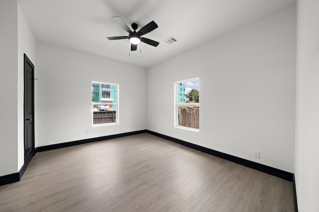 spare room featuring light wood-type flooring and ceiling fan