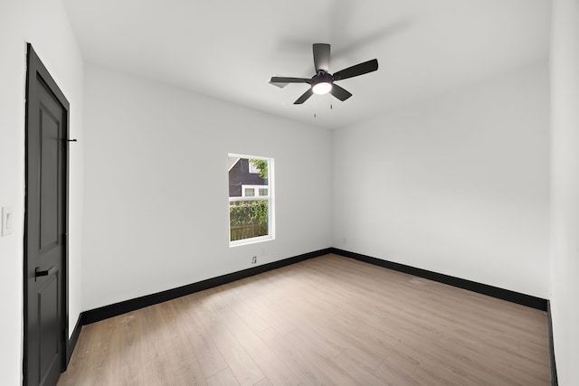 empty room featuring light wood-type flooring and ceiling fan