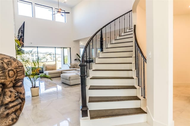 stairs with an inviting chandelier and a high ceiling