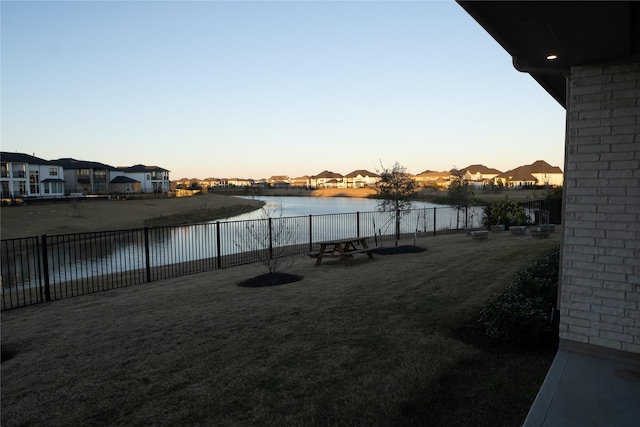 yard at dusk with a water view