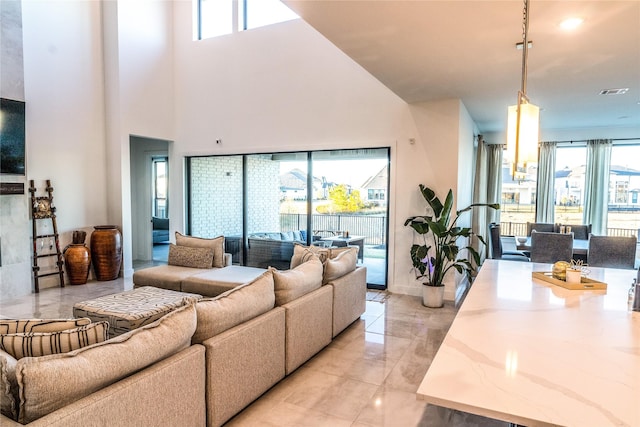 living room featuring a towering ceiling