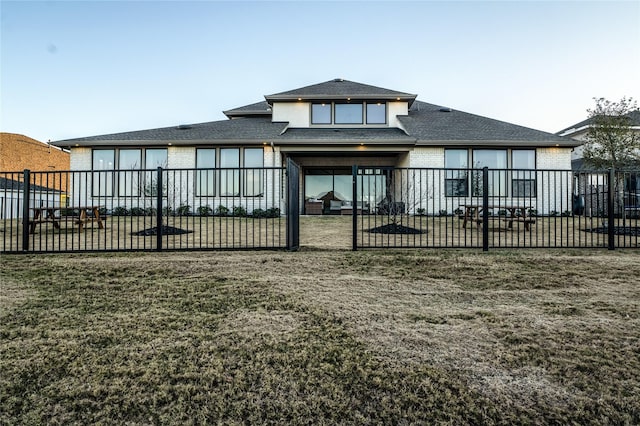 rear view of house with a yard