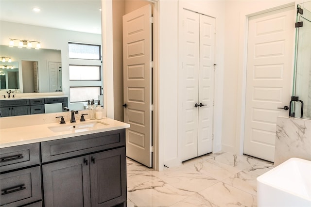 bathroom with a washtub and vanity