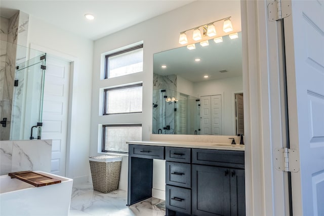 bathroom with vanity and independent shower and bath