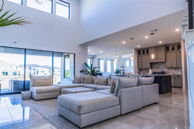 living room featuring a high ceiling and sink