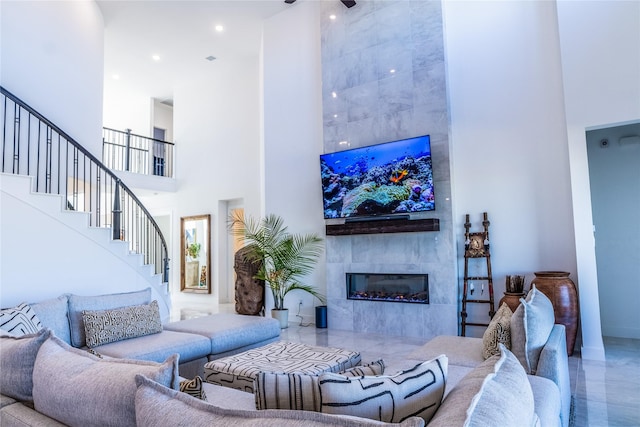 living room featuring a towering ceiling and a fireplace