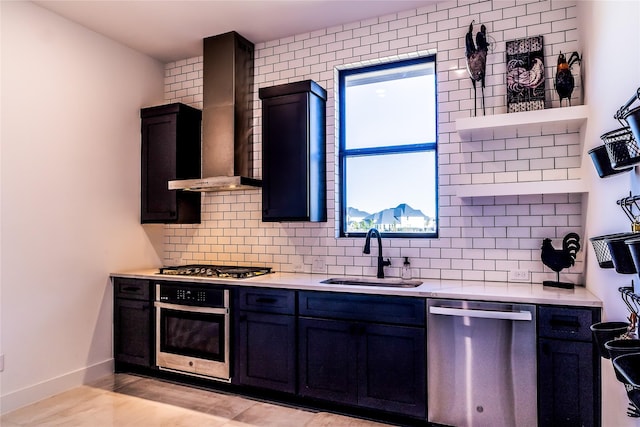 kitchen featuring backsplash, stainless steel appliances, sink, and wall chimney range hood