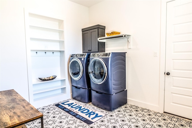 clothes washing area with cabinets, separate washer and dryer, and light tile patterned floors