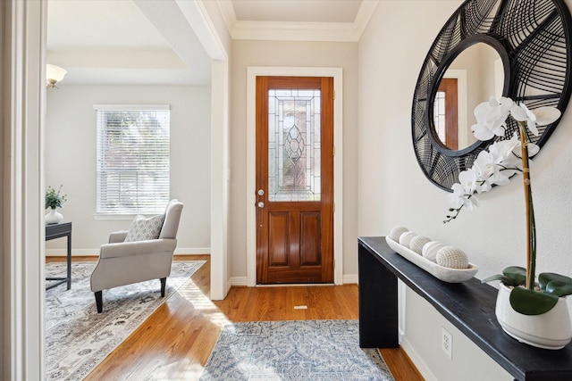 entrance foyer featuring crown molding and light hardwood / wood-style floors