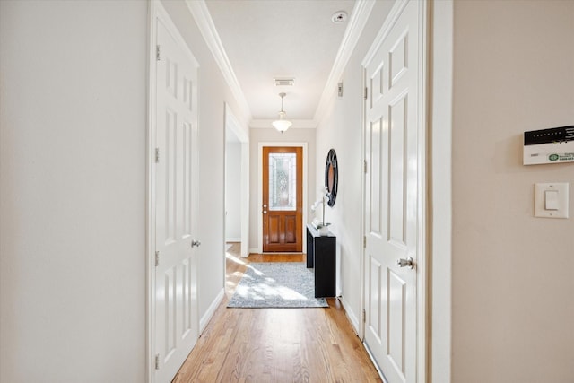 hall featuring light hardwood / wood-style flooring and crown molding