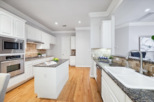 kitchen featuring sink, light hardwood / wood-style floors, white cabinetry, and appliances with stainless steel finishes