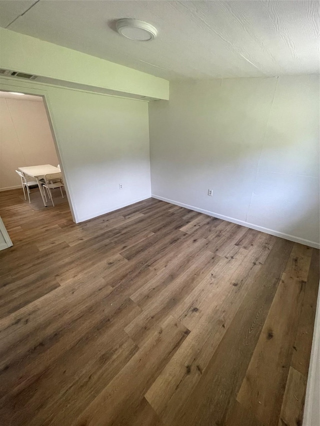 unfurnished room featuring dark hardwood / wood-style flooring