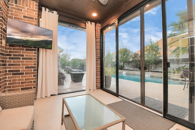 doorway to outside with expansive windows, a wealth of natural light, and tile patterned floors