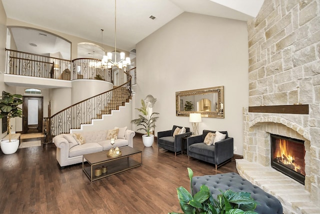 living room featuring hardwood / wood-style floors, a fireplace, and high vaulted ceiling