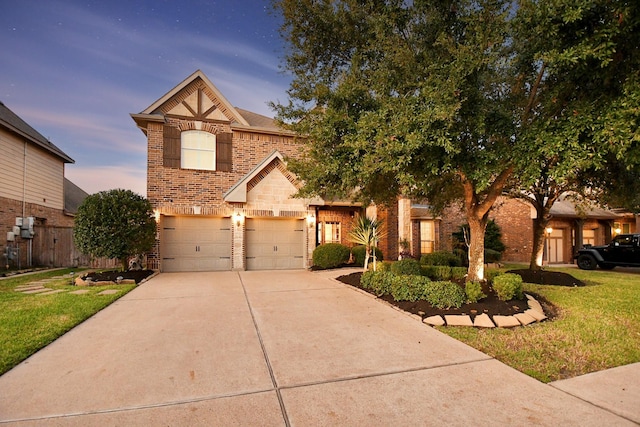 view of front of property with a garage and a lawn