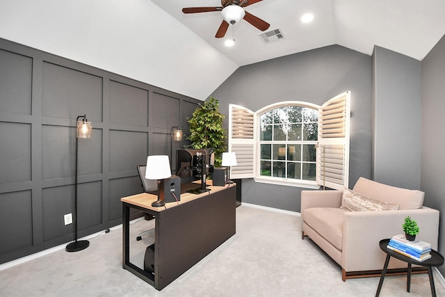 home office featuring light carpet, vaulted ceiling, and ceiling fan