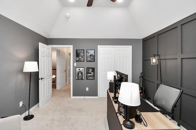 carpeted office with vaulted ceiling and ceiling fan