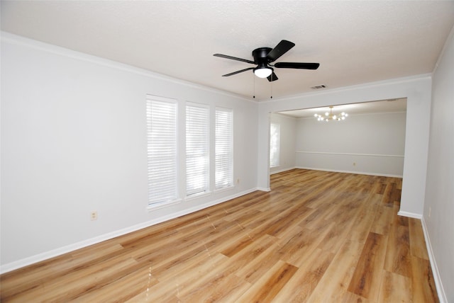 unfurnished room featuring ceiling fan with notable chandelier, light hardwood / wood-style flooring, and ornamental molding