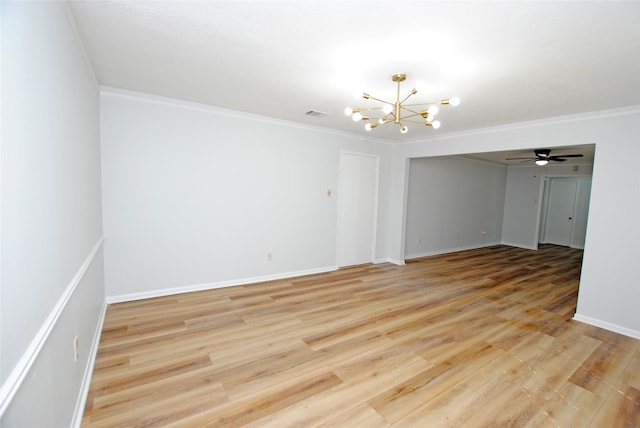 empty room with crown molding, light wood-type flooring, and ceiling fan with notable chandelier