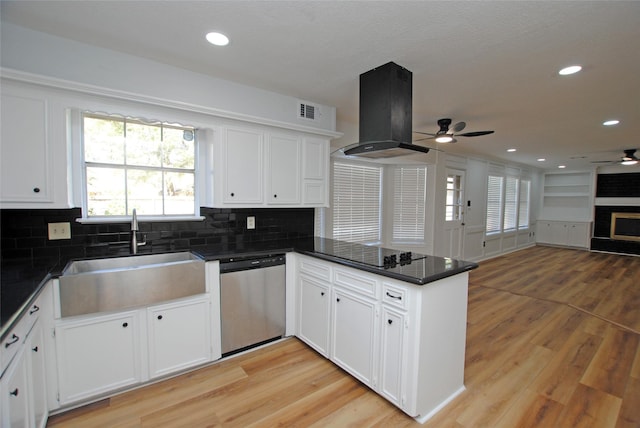 kitchen featuring dishwasher, island exhaust hood, white cabinets, sink, and kitchen peninsula