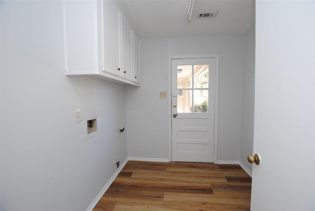 laundry room with hookup for a washing machine, cabinets, and wood-type flooring