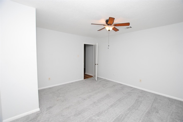 carpeted empty room with ceiling fan