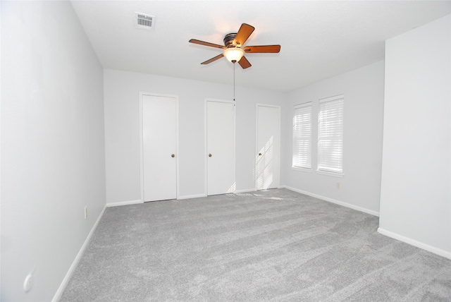 unfurnished room featuring light colored carpet and ceiling fan