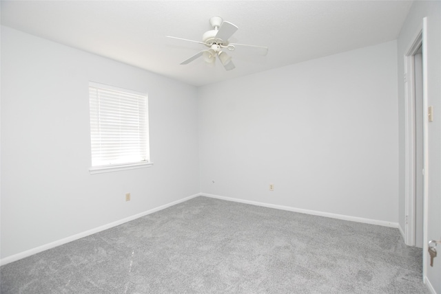 spare room with light carpet and ceiling fan