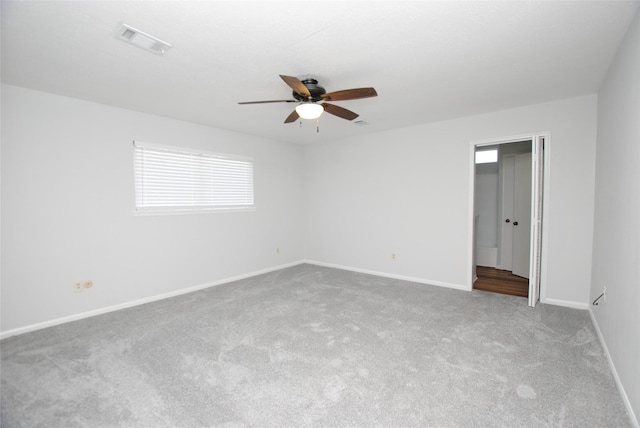 unfurnished room featuring light carpet and ceiling fan