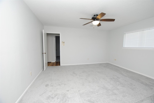 unfurnished room with ceiling fan and light carpet