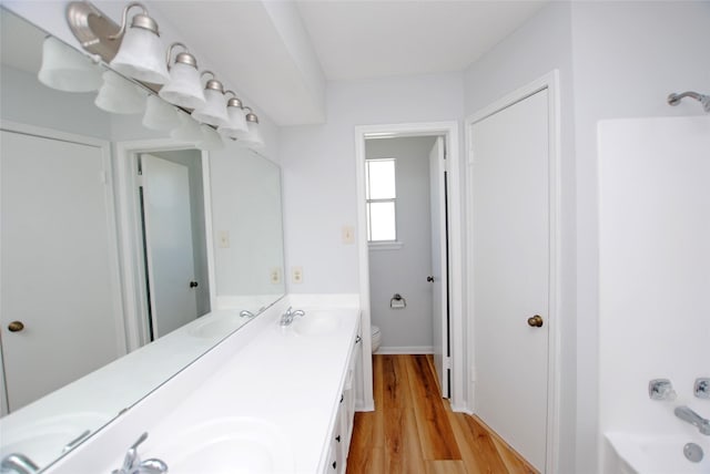 bathroom featuring hardwood / wood-style floors, toilet, and vanity