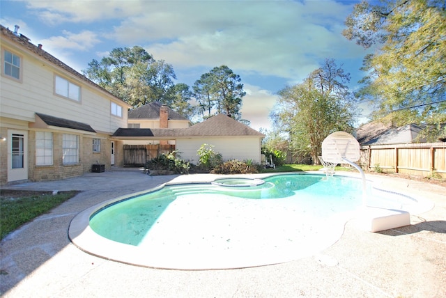 view of swimming pool featuring an in ground hot tub and a patio