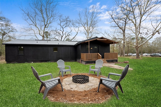 view of yard featuring a wooden deck and a fire pit