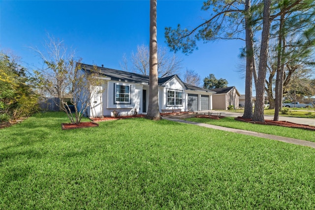 single story home featuring a garage and a front lawn