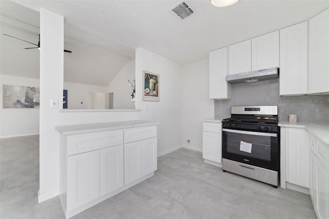 kitchen with white cabinets, lofted ceiling, gas stove, backsplash, and ceiling fan