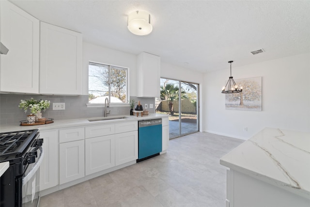 kitchen featuring stainless steel dishwasher, pendant lighting, sink, white cabinetry, and gas stove