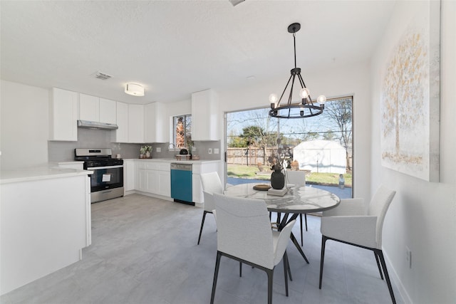 dining area with sink and a chandelier