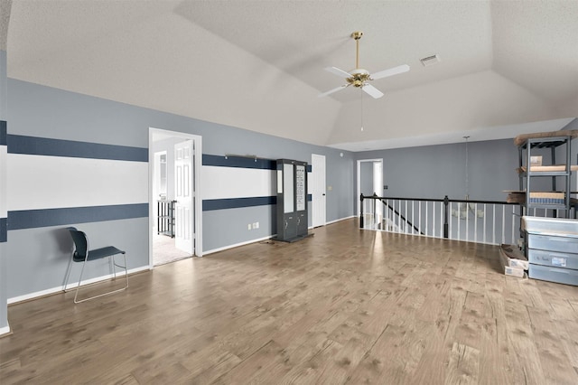 unfurnished living room featuring wood-type flooring, ceiling fan, and lofted ceiling