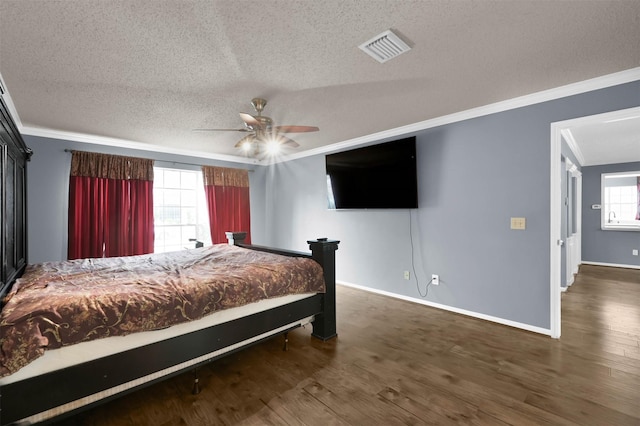 bedroom featuring crown molding, multiple windows, and ceiling fan