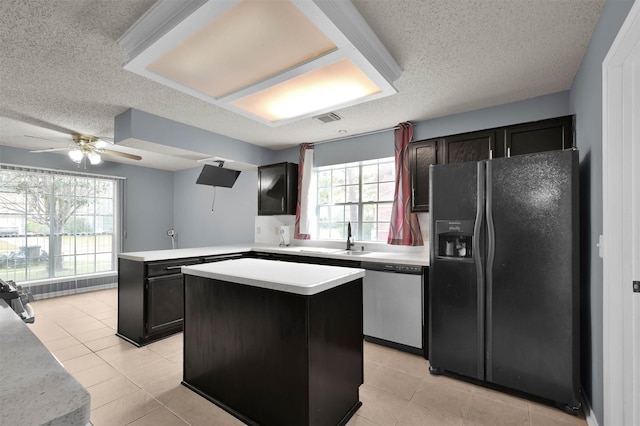 kitchen with black refrigerator with ice dispenser, dishwasher, a healthy amount of sunlight, and a kitchen island