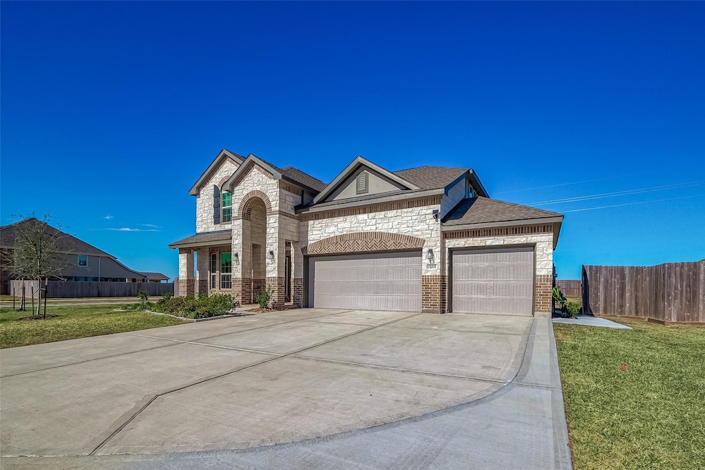 view of front of home with a garage and a front lawn