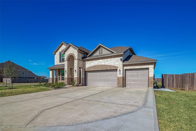 view of front of home with a garage and a front lawn