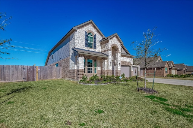 view of front of property with a garage and a front lawn