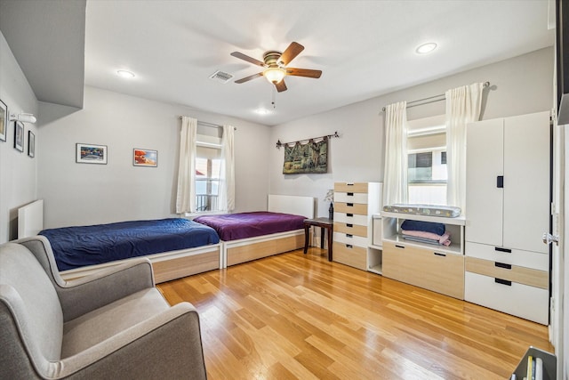 bedroom with ceiling fan and hardwood / wood-style floors