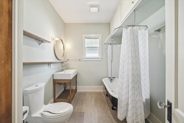 bathroom featuring toilet and shower / bath combo with shower curtain